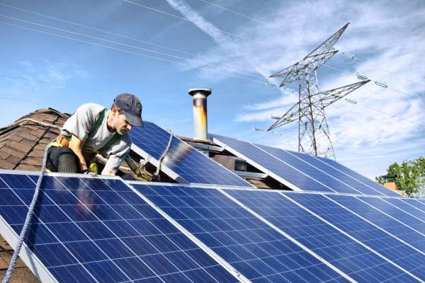 Solar panels being installed on a house roof